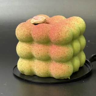 Pistachio cherry mousse dessert with pistachio biscuit and cherry filling