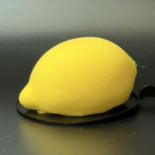 Lemon-shaped mousse dessert with lemon curd and chocolate shell